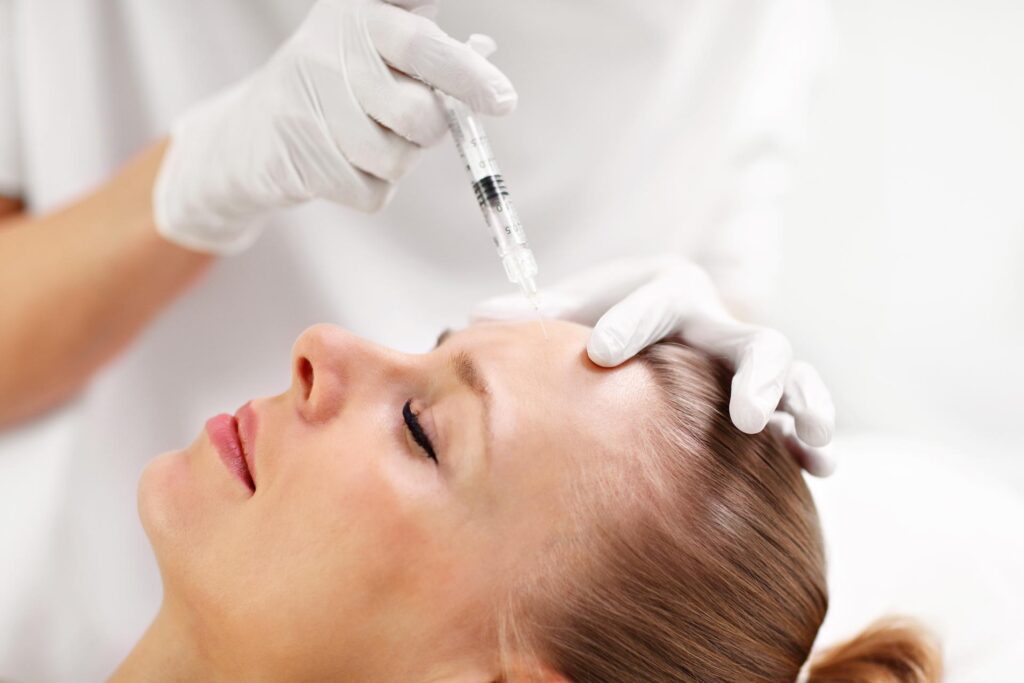 close up of hands of cosmetologist making botox